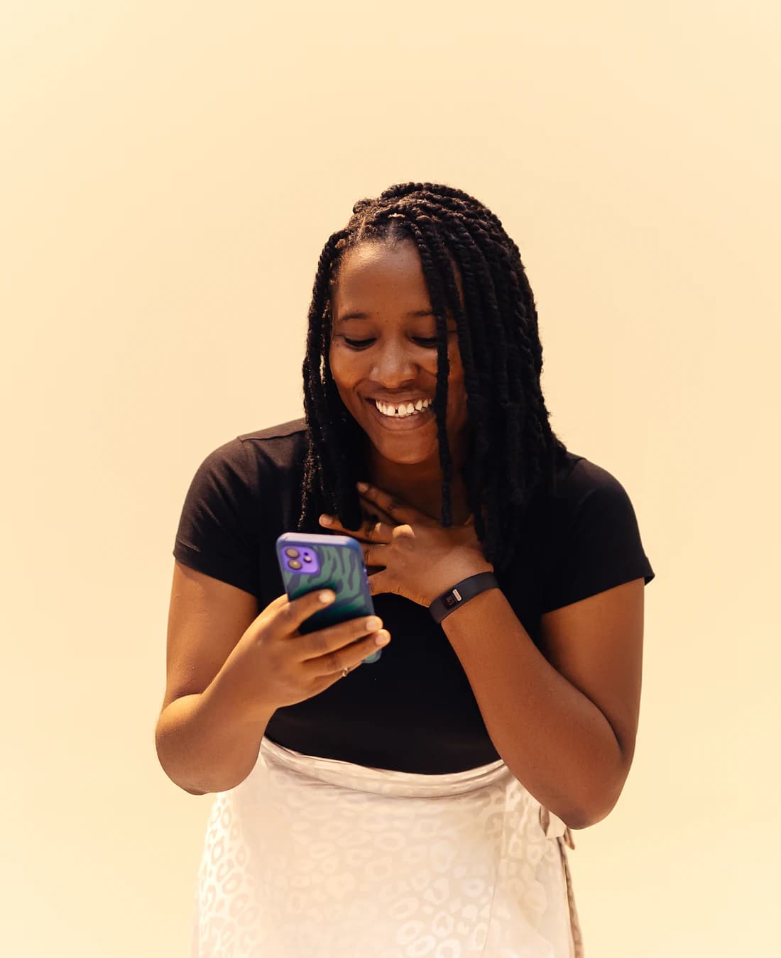 A happy TYDATA customer using her phone in Lagos